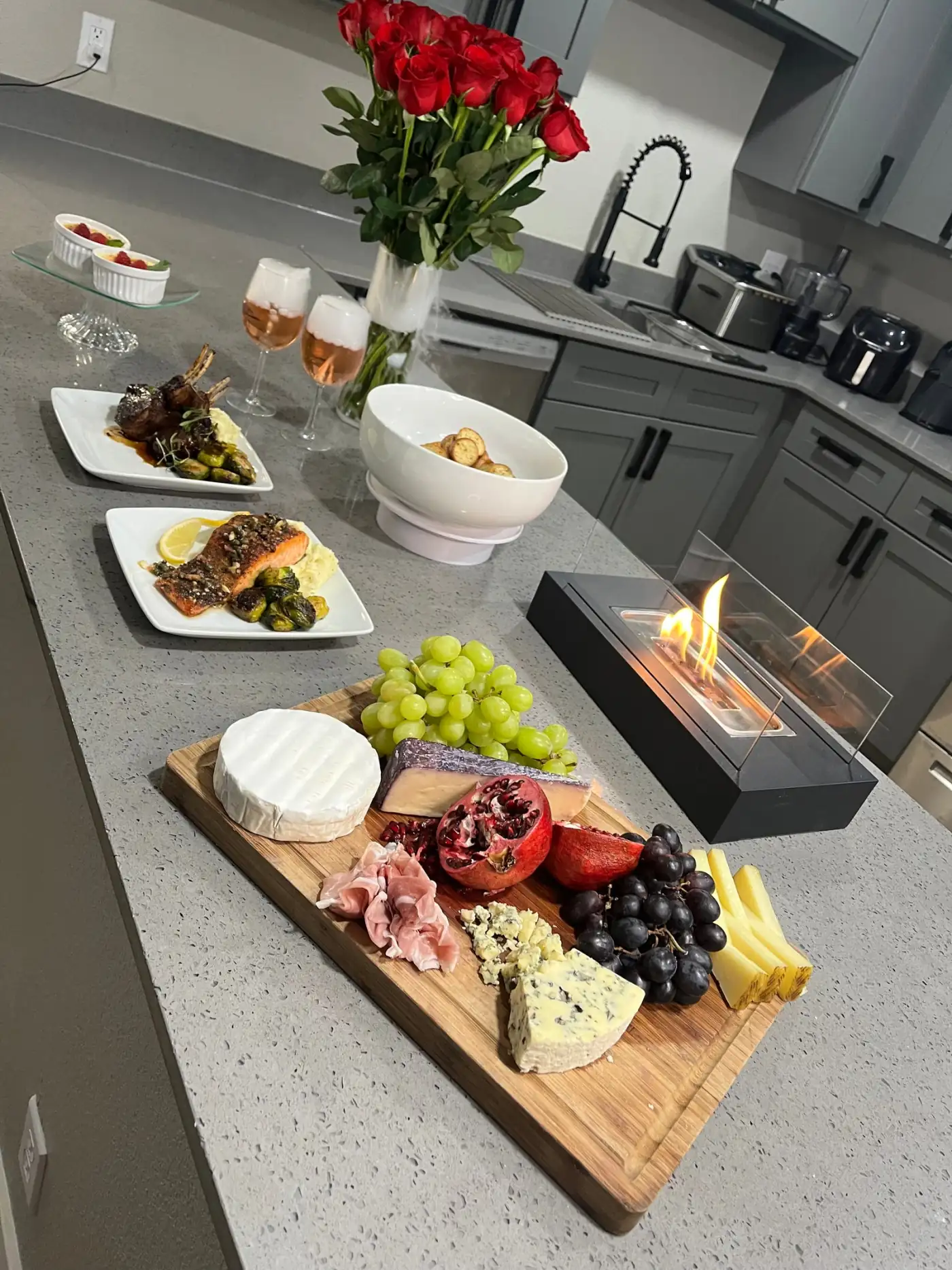 HumbledHandz private date night: charcuterie board, lamb chops, pesto-crusted salmon, rose, red roses and a tabletop fire