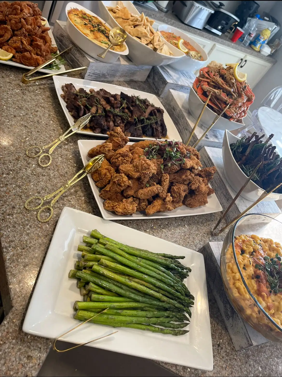 HumbledHandz dinner buffet: fried shrimp, spinach-artichoke dip, steak bites, fried chicken, seasoned crab, lamb chops, baked mac and cheese, asparagus